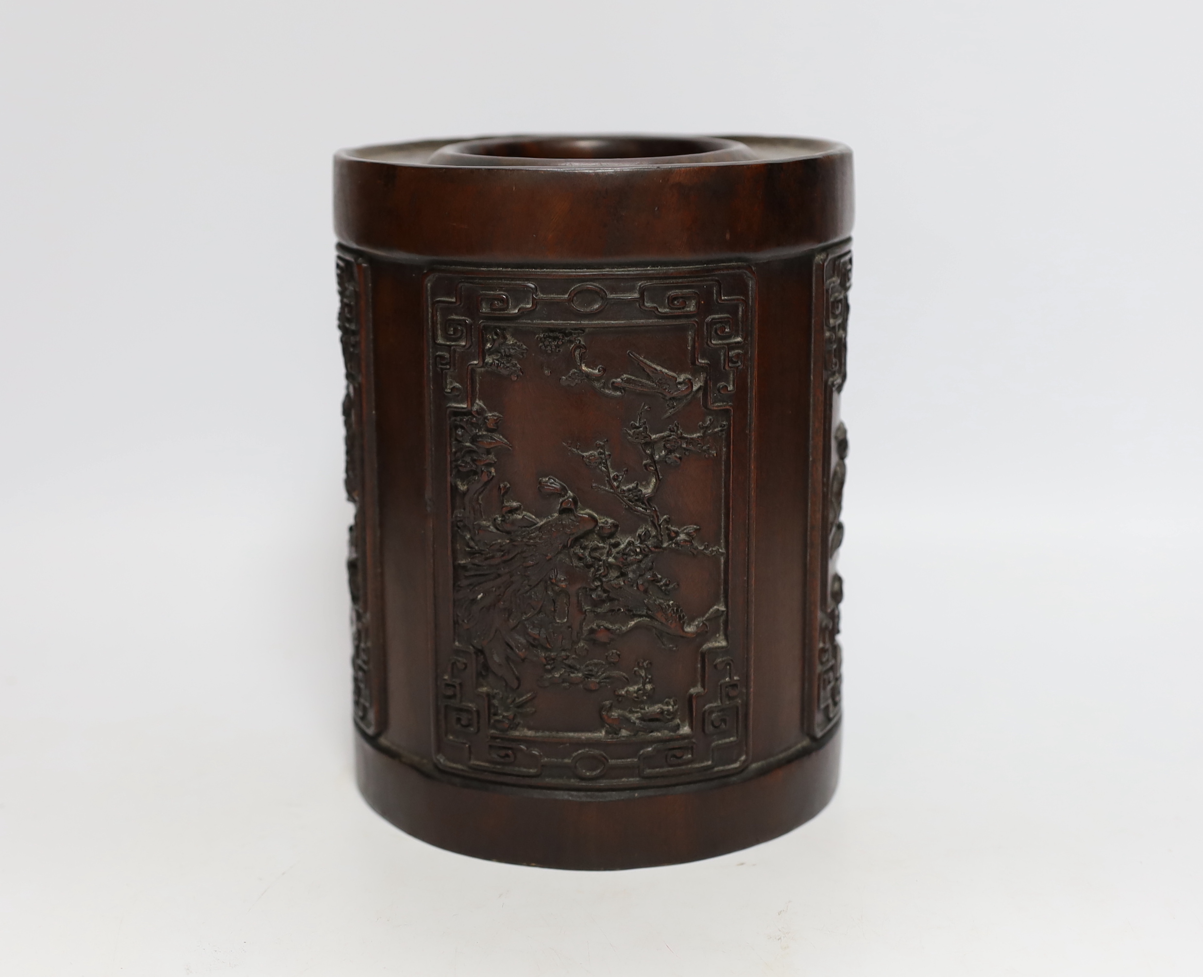 A heavy Chinese wooden brush pot decorated with birds, possibly Zitan, 20cm high